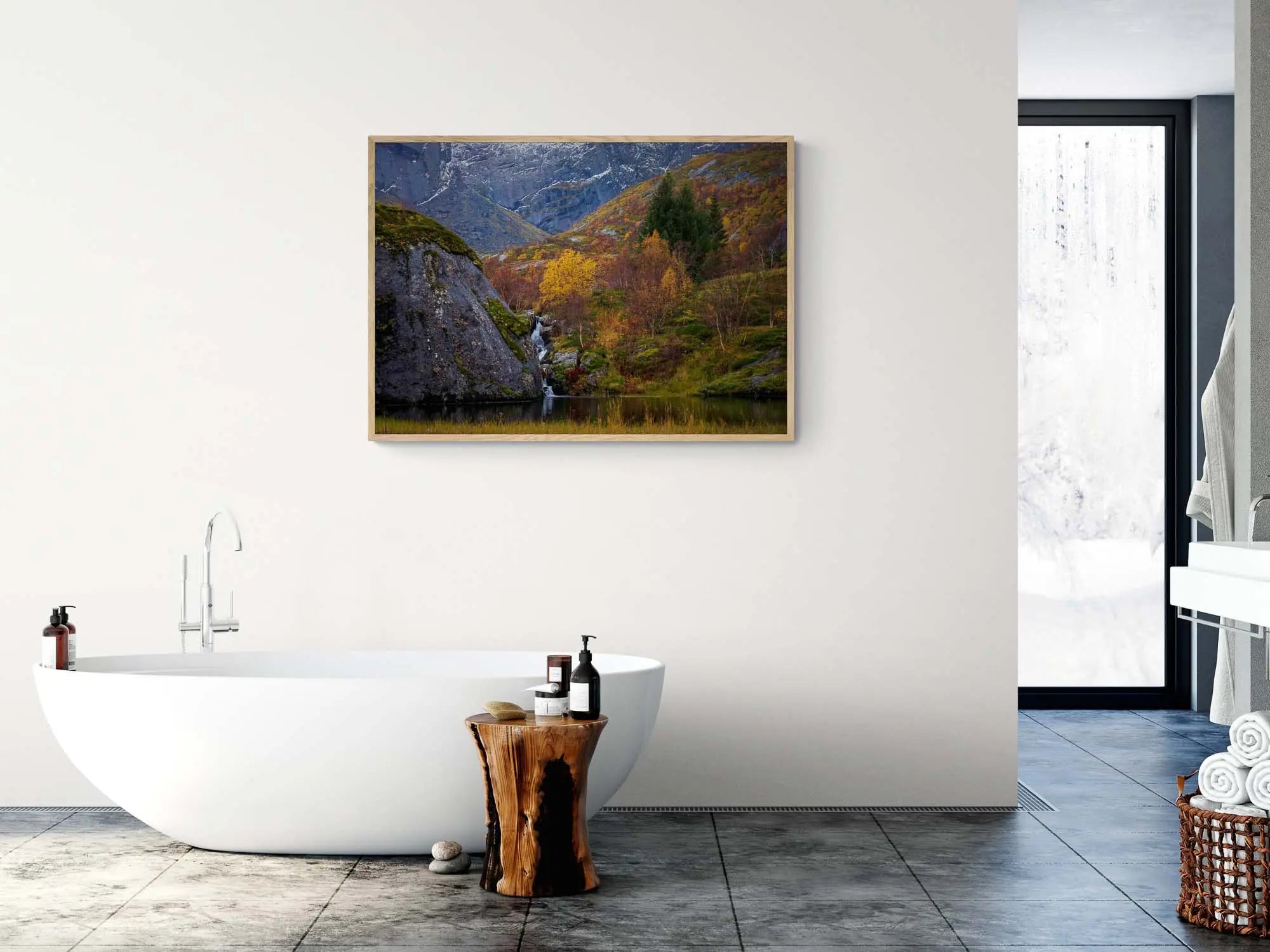 Small waterfall flowing into a pond amidst colorful autumn trees in Nusfjord, Lofoten, with rugged cliffs in the background.
