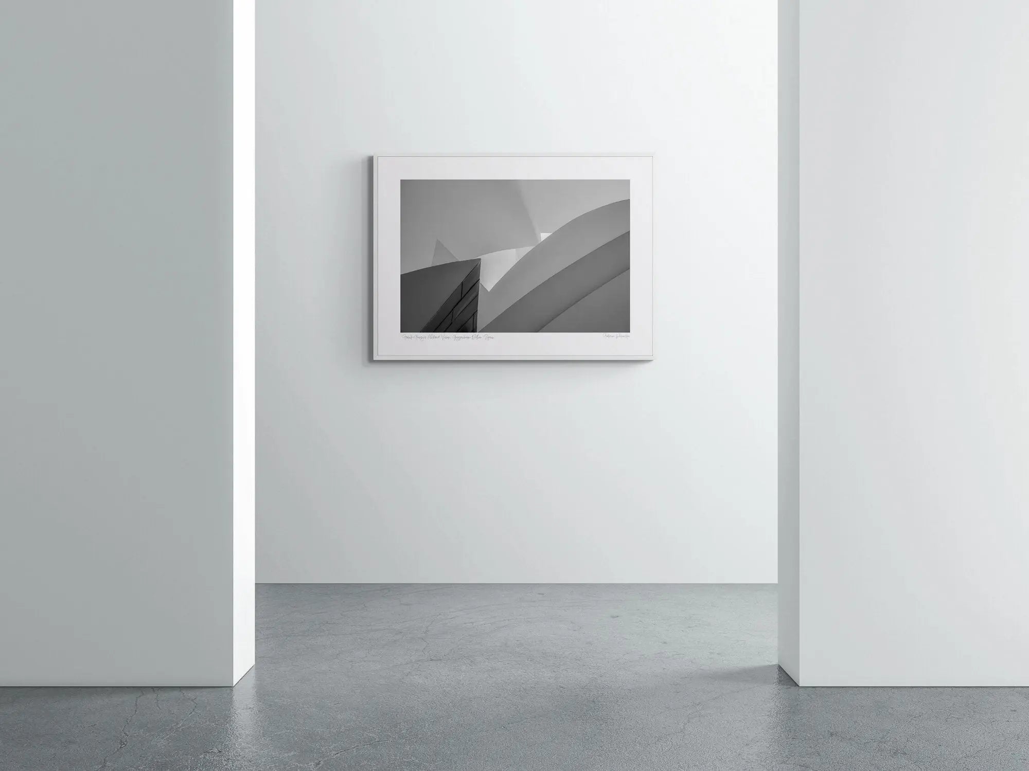 "Black and white photograph showcasing the abstract geometric forms of the Guggenheim Museum in Bilbao."