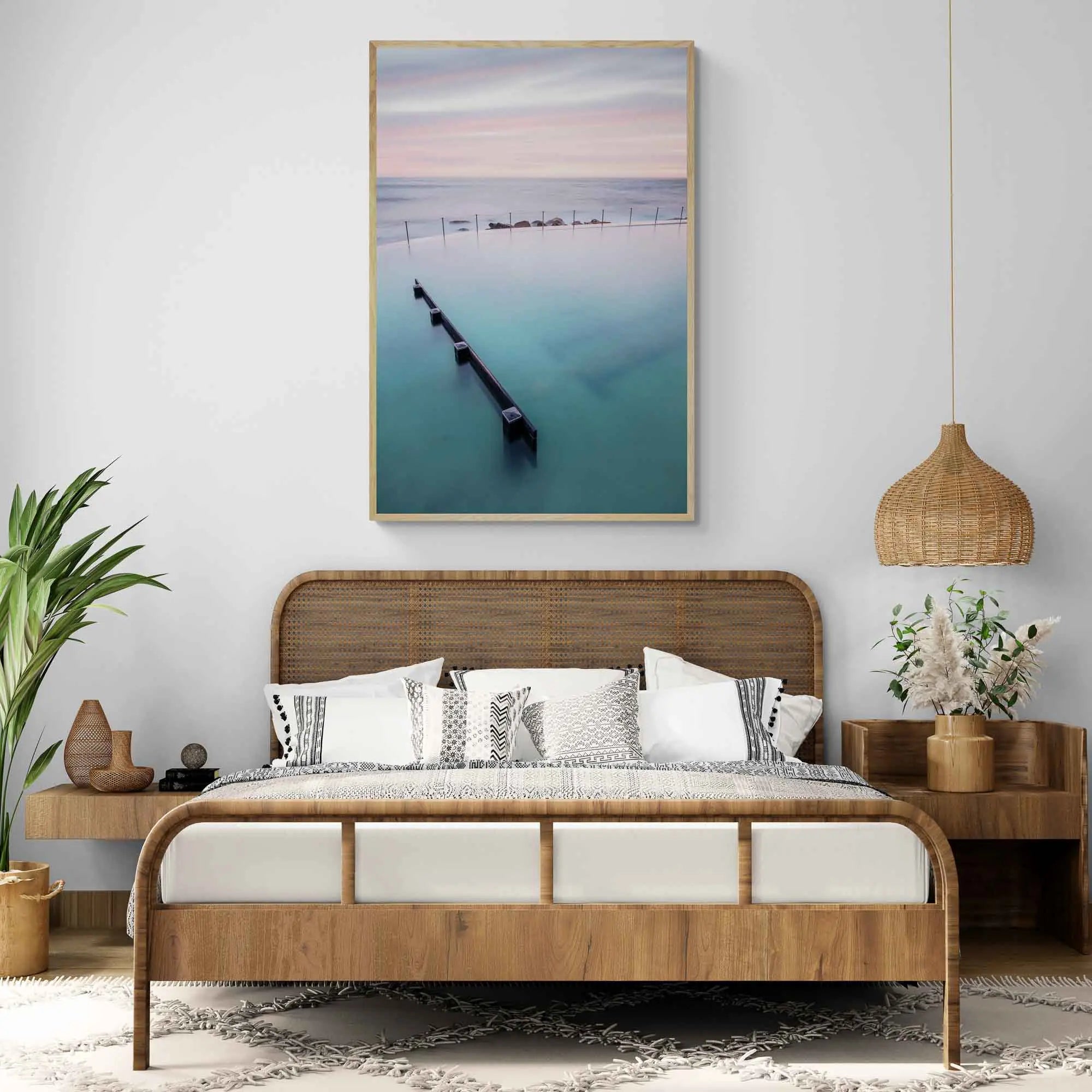 Long exposure of Bronte Baths in Sydney, with smooth waters under a pink and blue striped sky at twilight.