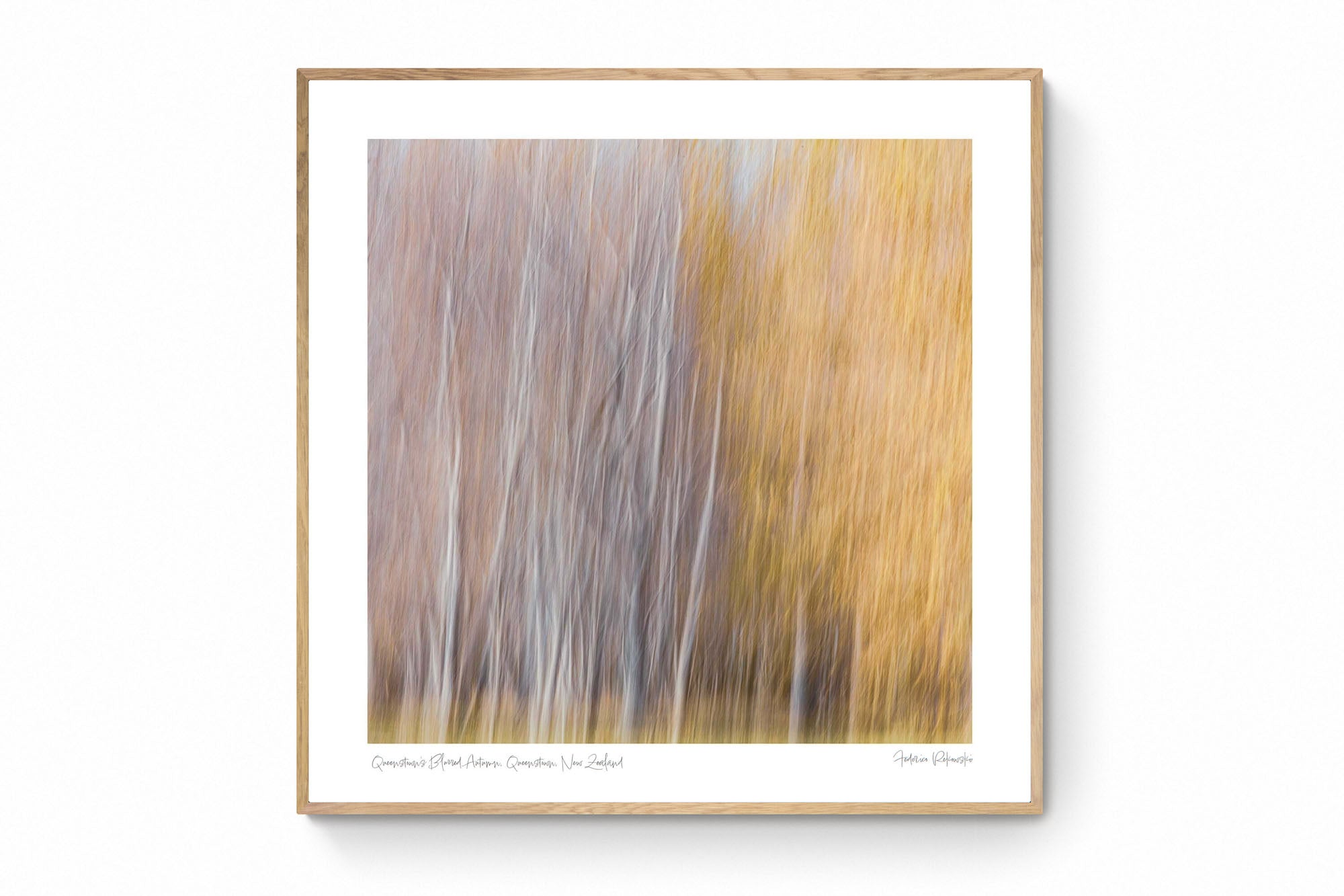 Abstract, blurred image of autumn trees in Queenstown, resembling an impressionistic painting with soft white and golden strokes.
