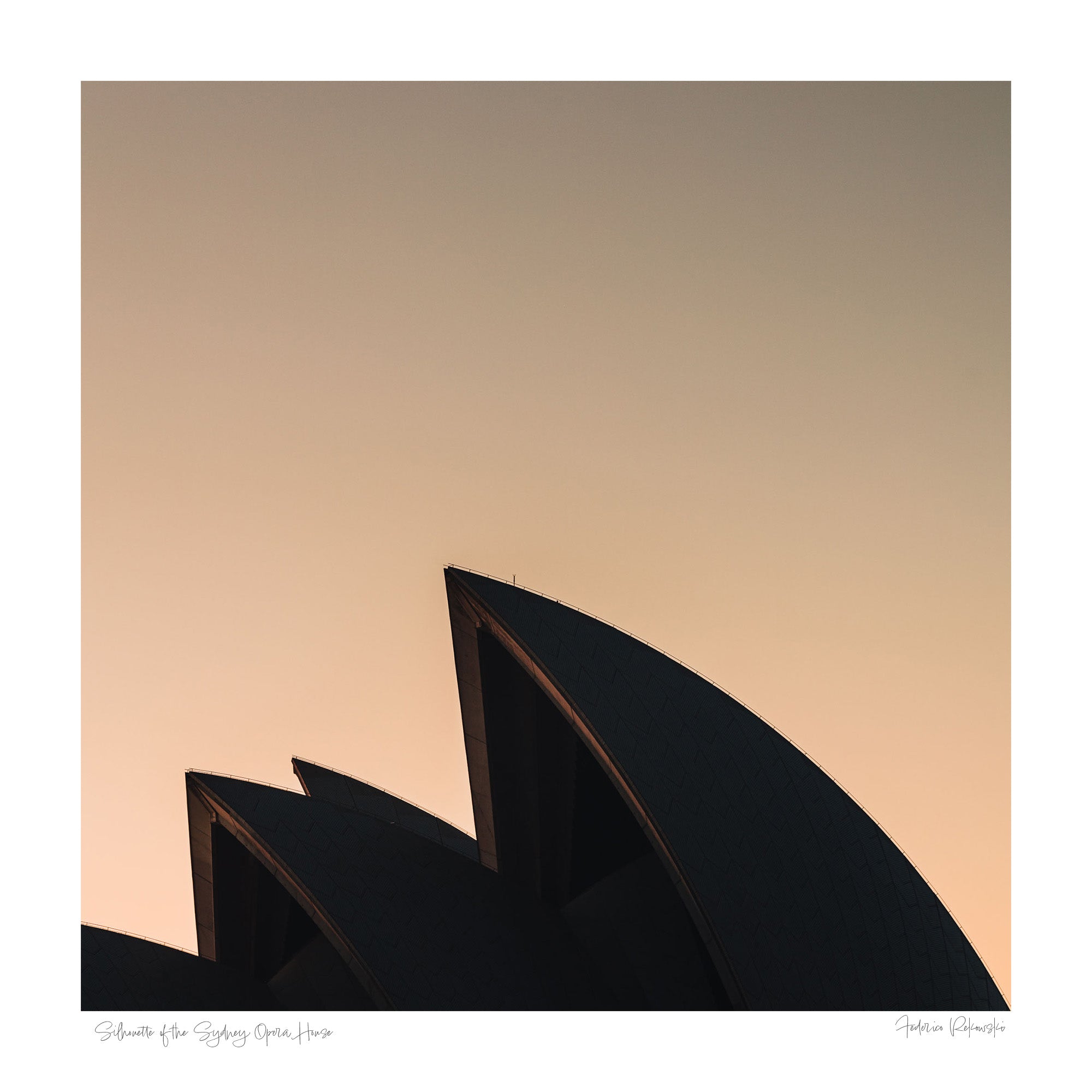 The iconic sails of the Sydney Opera House in silhouette against the warm tones of sunrise.
