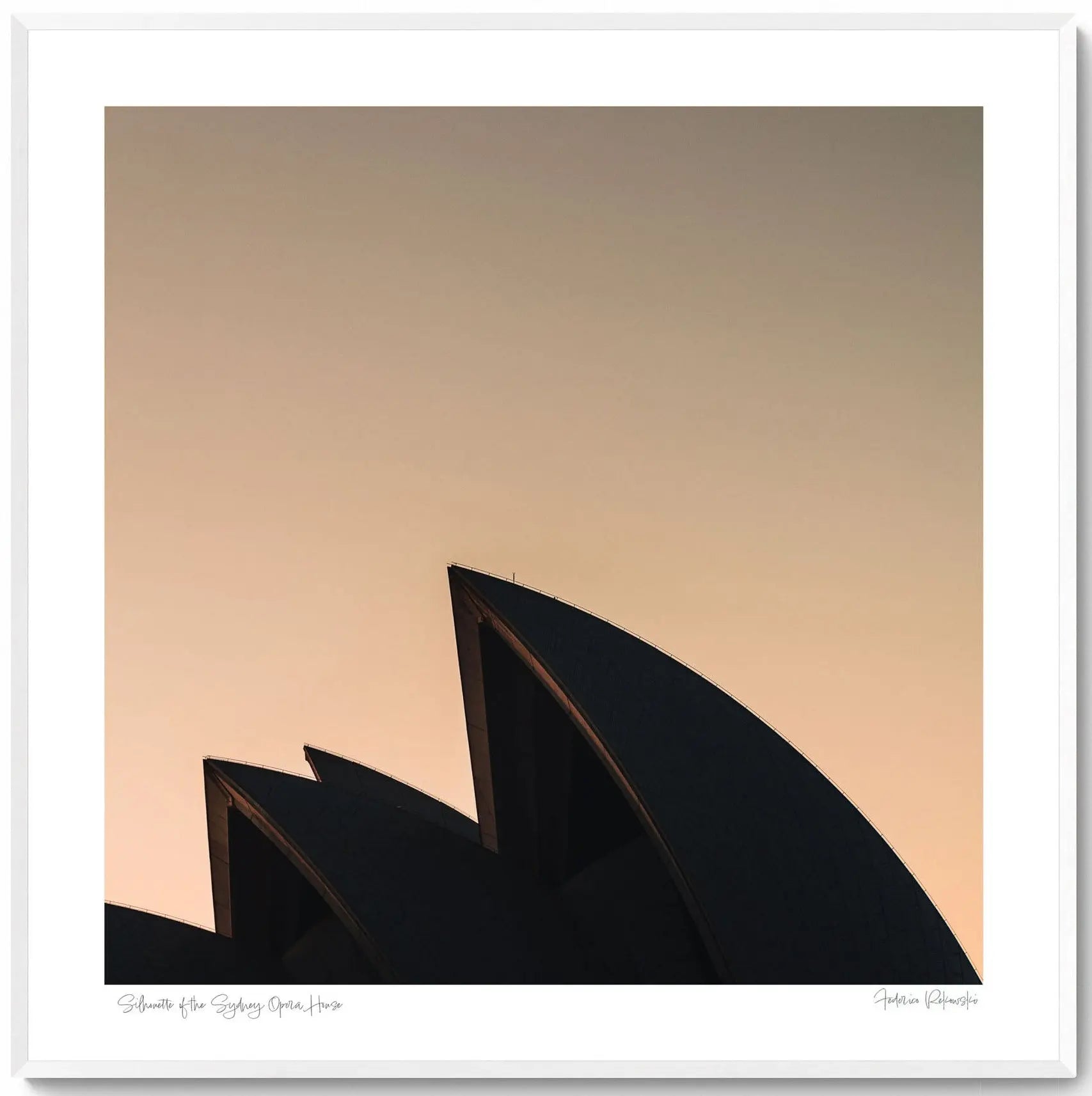 The iconic sails of the Sydney Opera House in silhouette against the warm tones of sunrise.