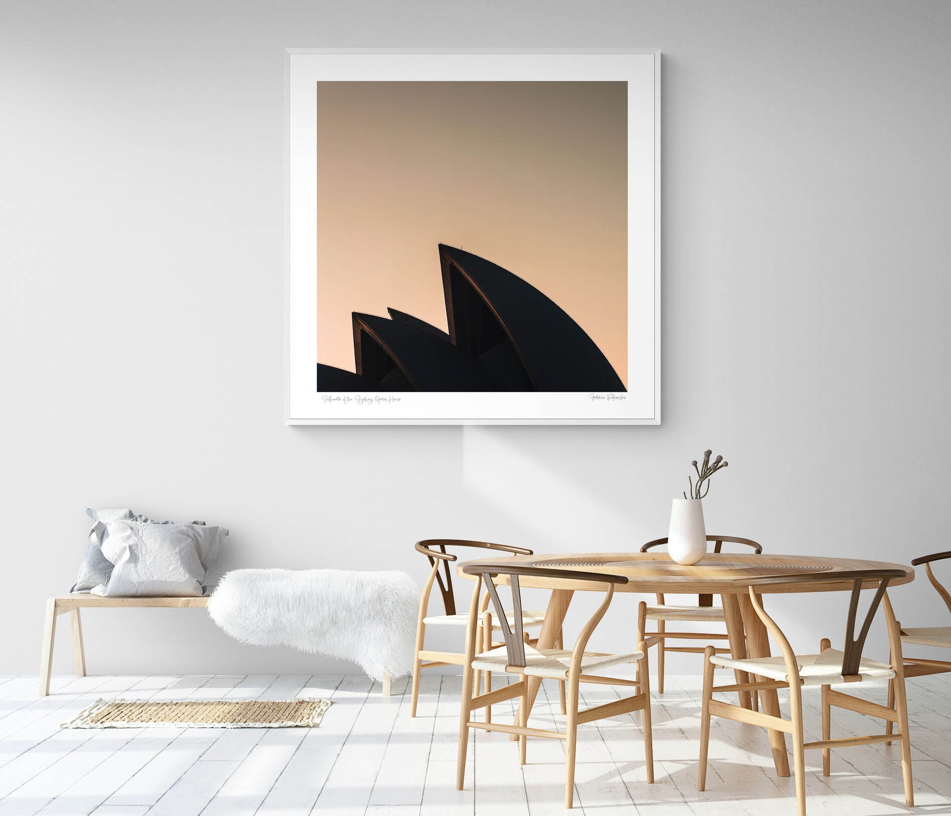The iconic sails of the Sydney Opera House in silhouette against the warm tones of sunrise.