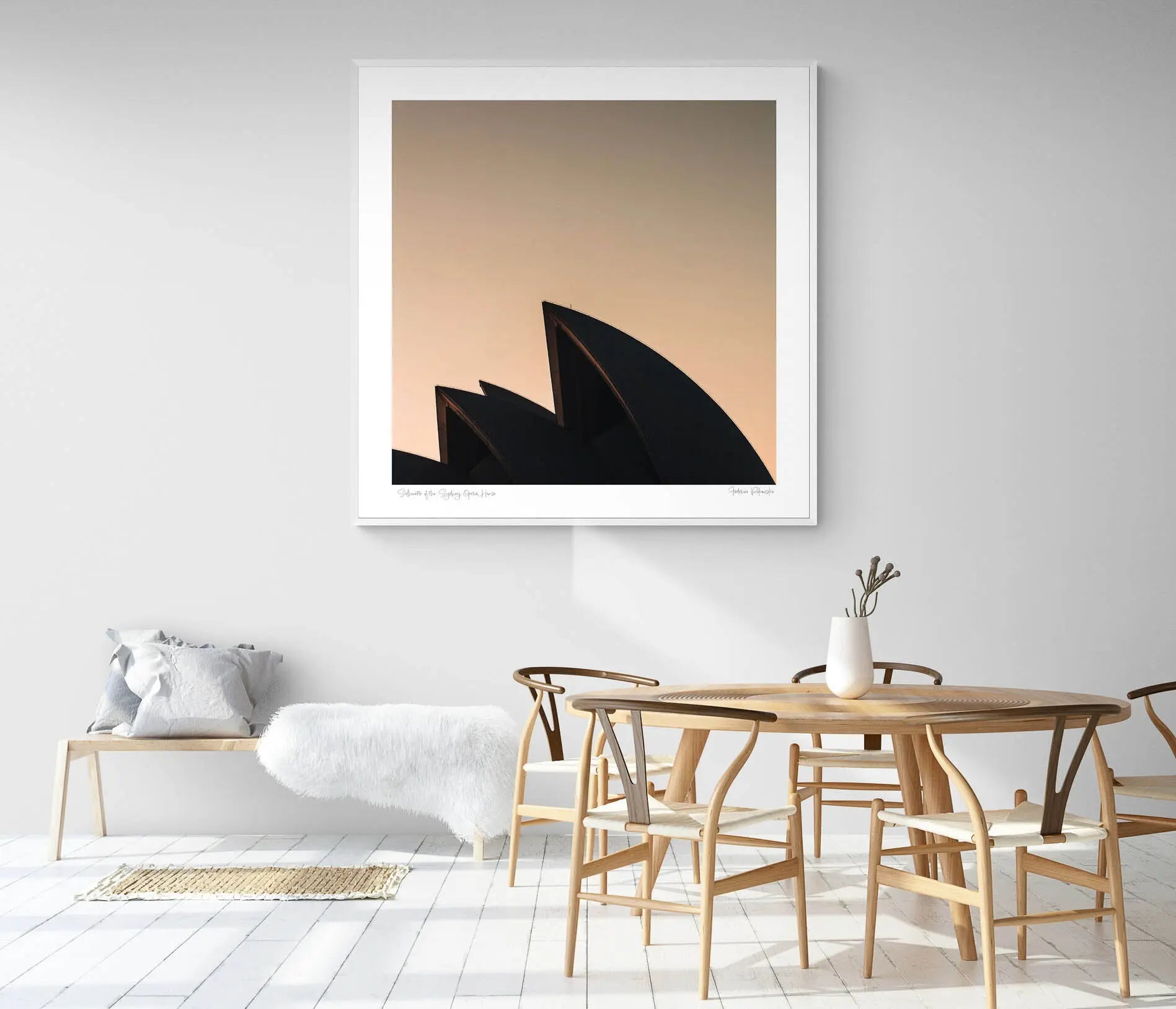The iconic sails of the Sydney Opera House in silhouette against the warm tones of sunrise.