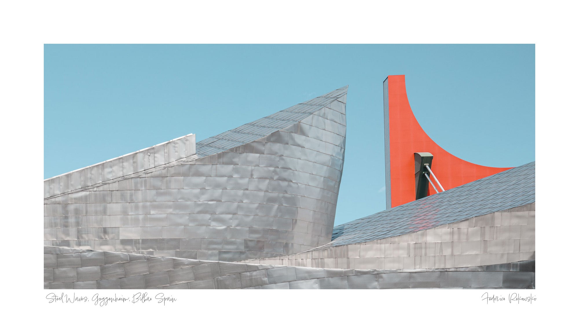 The Guggenheim Museum Bilbao, with its metallic curves contrasted by a bright red architectural feature against a clear blue sky.