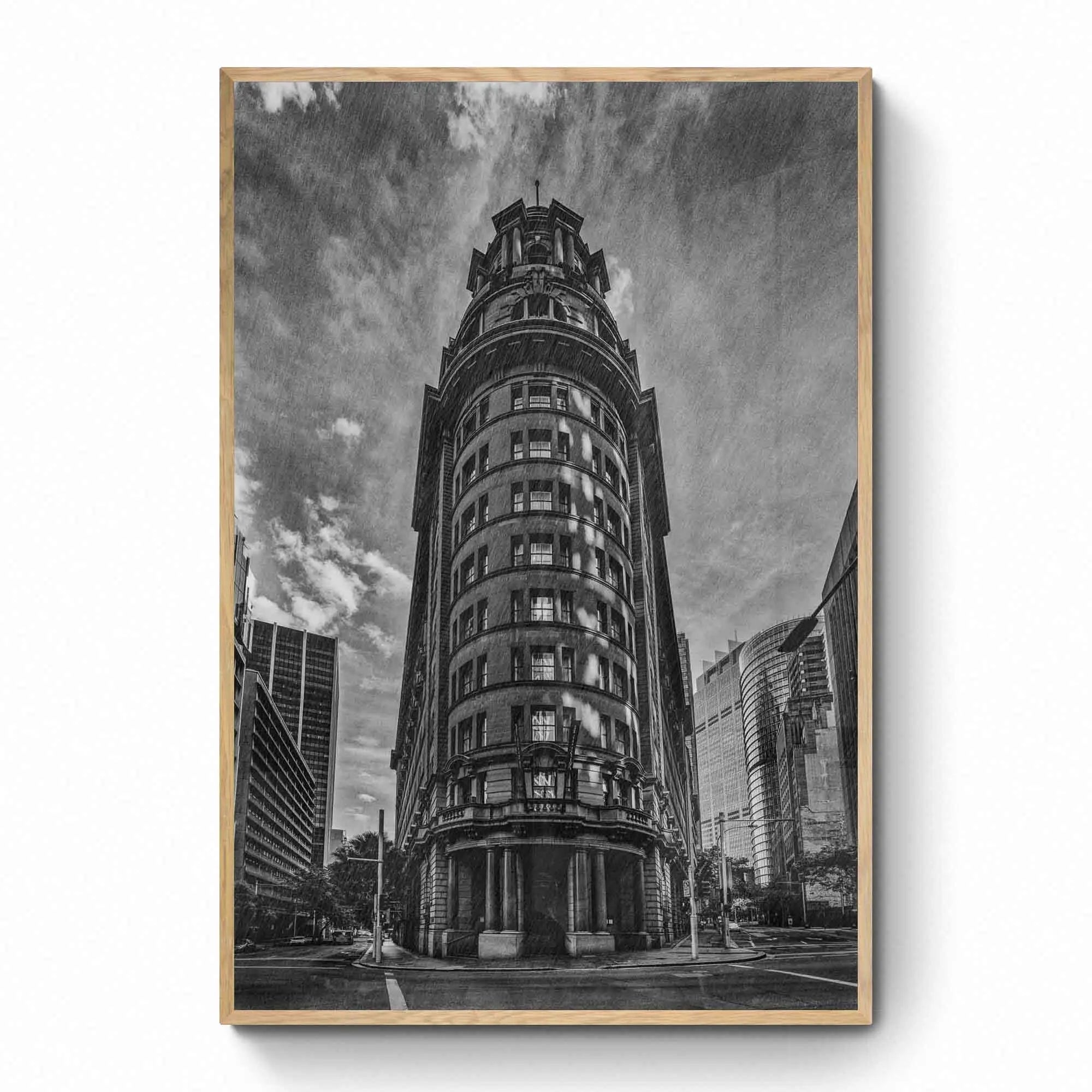 Black and white photo of an ornate, historic building in Sydney, Australia, with a dramatic sky in the background.