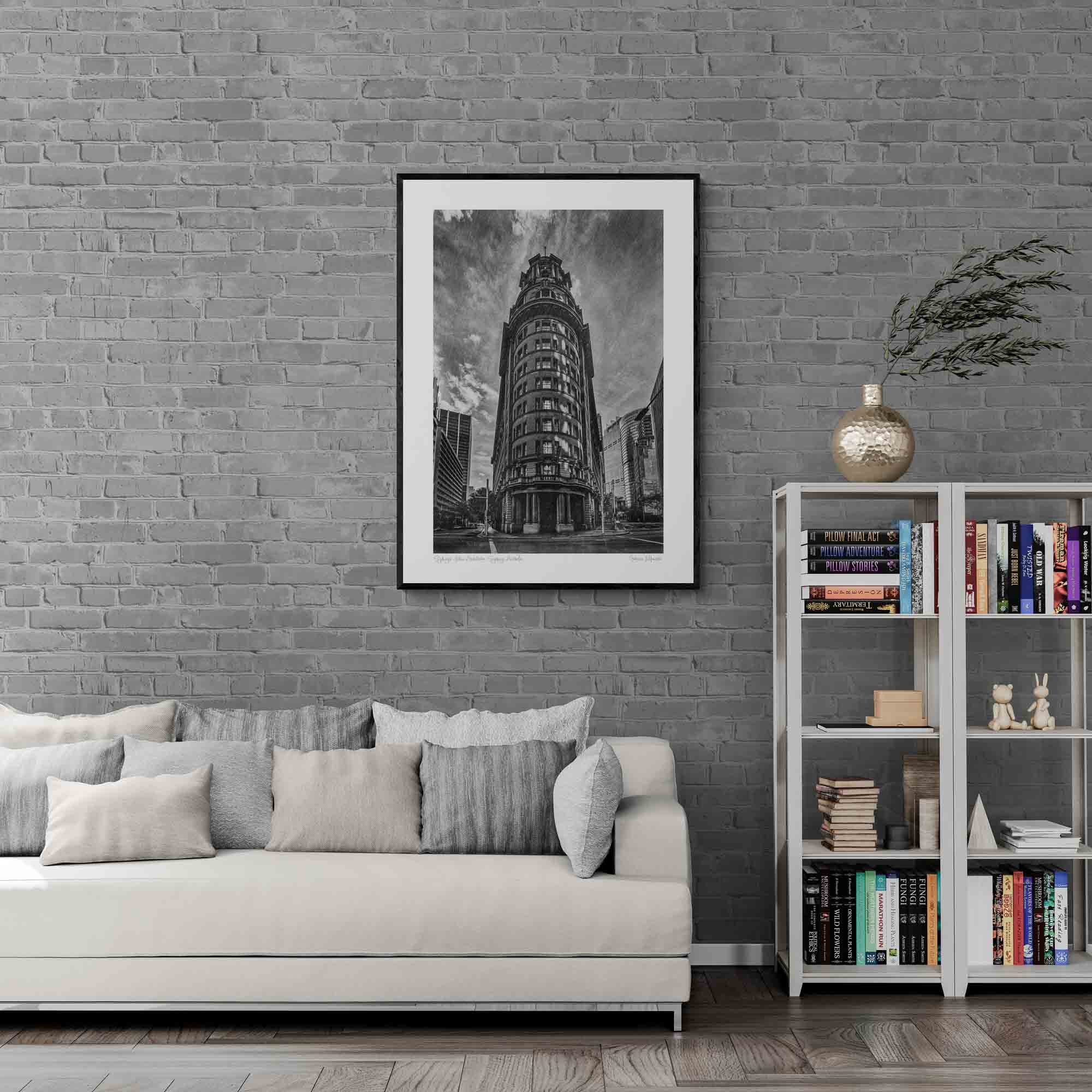 Black and white photo of an ornate, historic building in Sydney, Australia, with a dramatic sky in the background.
