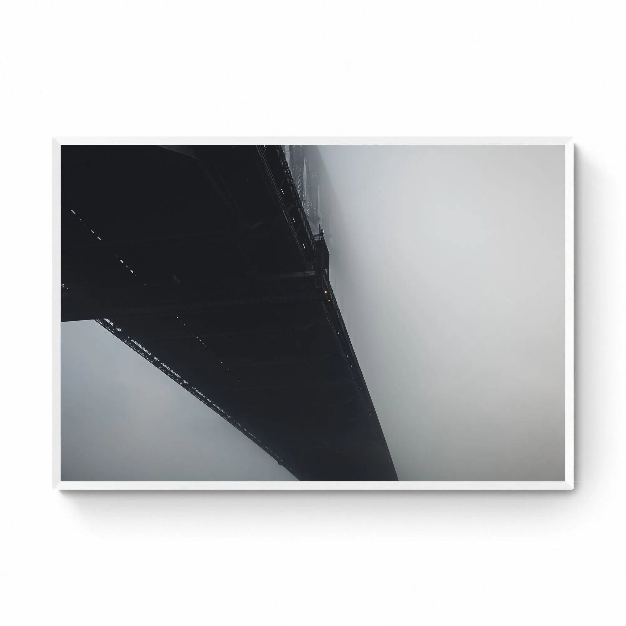 The Sydney Harbour Bridge partially obscured by fog, with its arch and lights fading into the white mist.