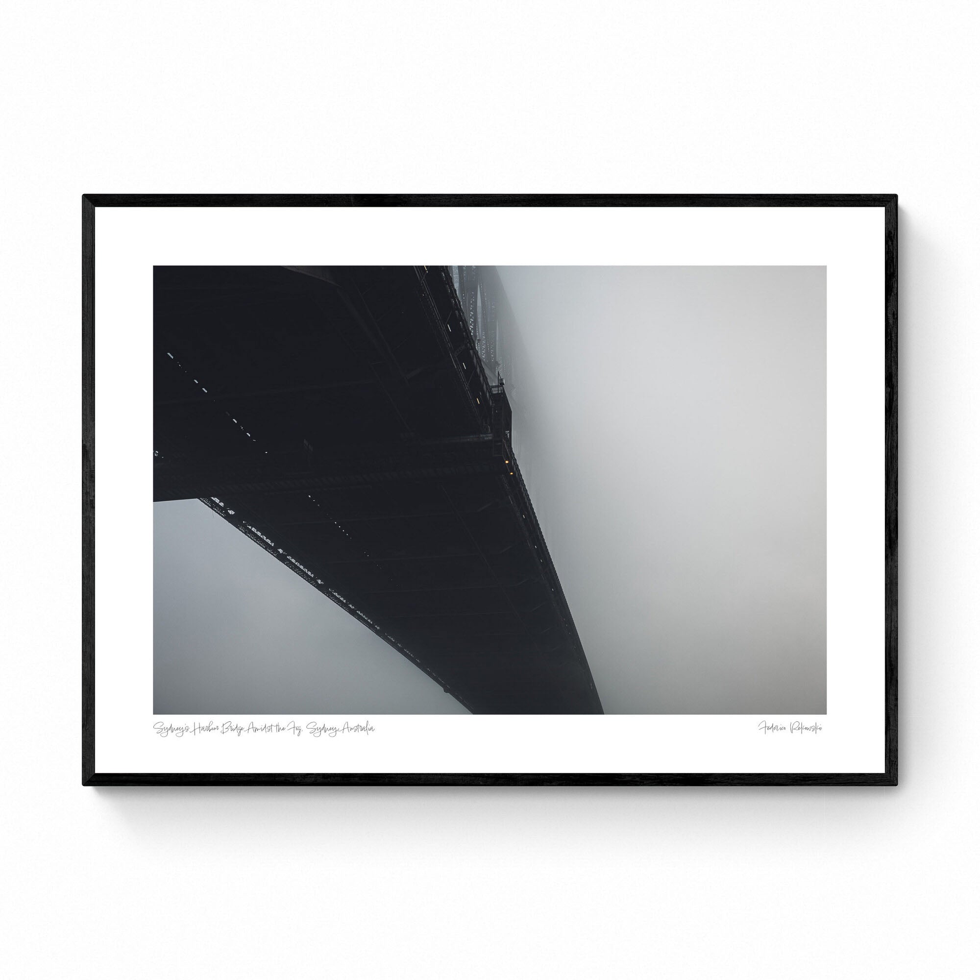 The Sydney Harbour Bridge partially obscured by fog, with its arch and lights fading into the white mist.