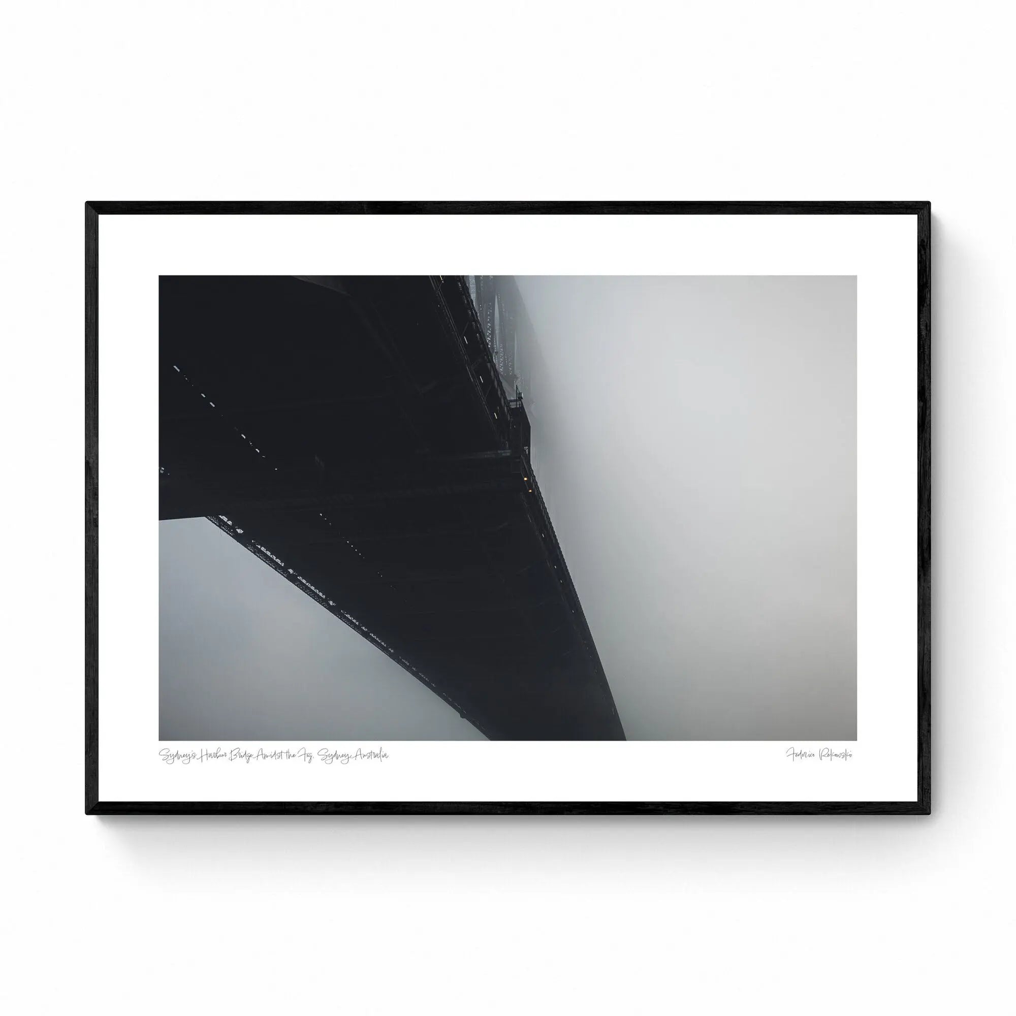 The Sydney Harbour Bridge partially obscured by fog, with its arch and lights fading into the white mist.