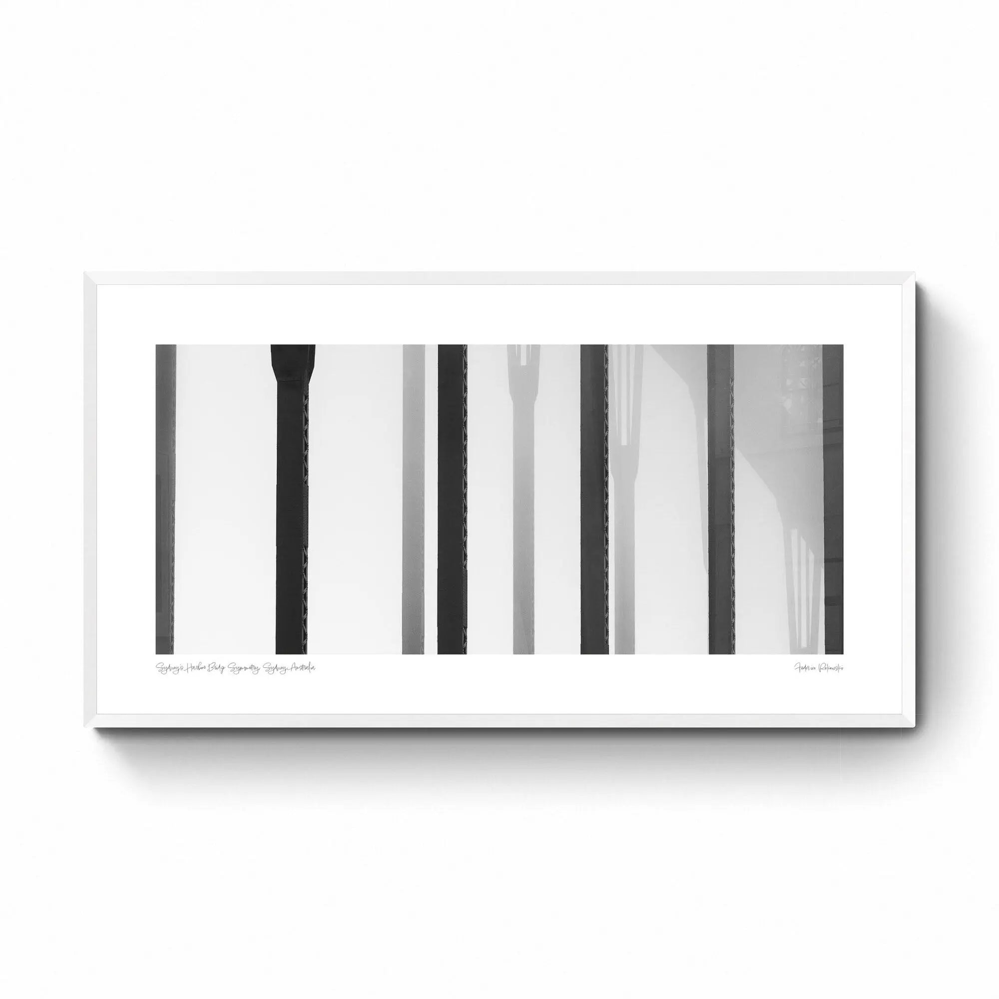 Black and white close-up of the vertical steel stanchions of Sydney Harbour Bridge, displaying a play of light and shadows.