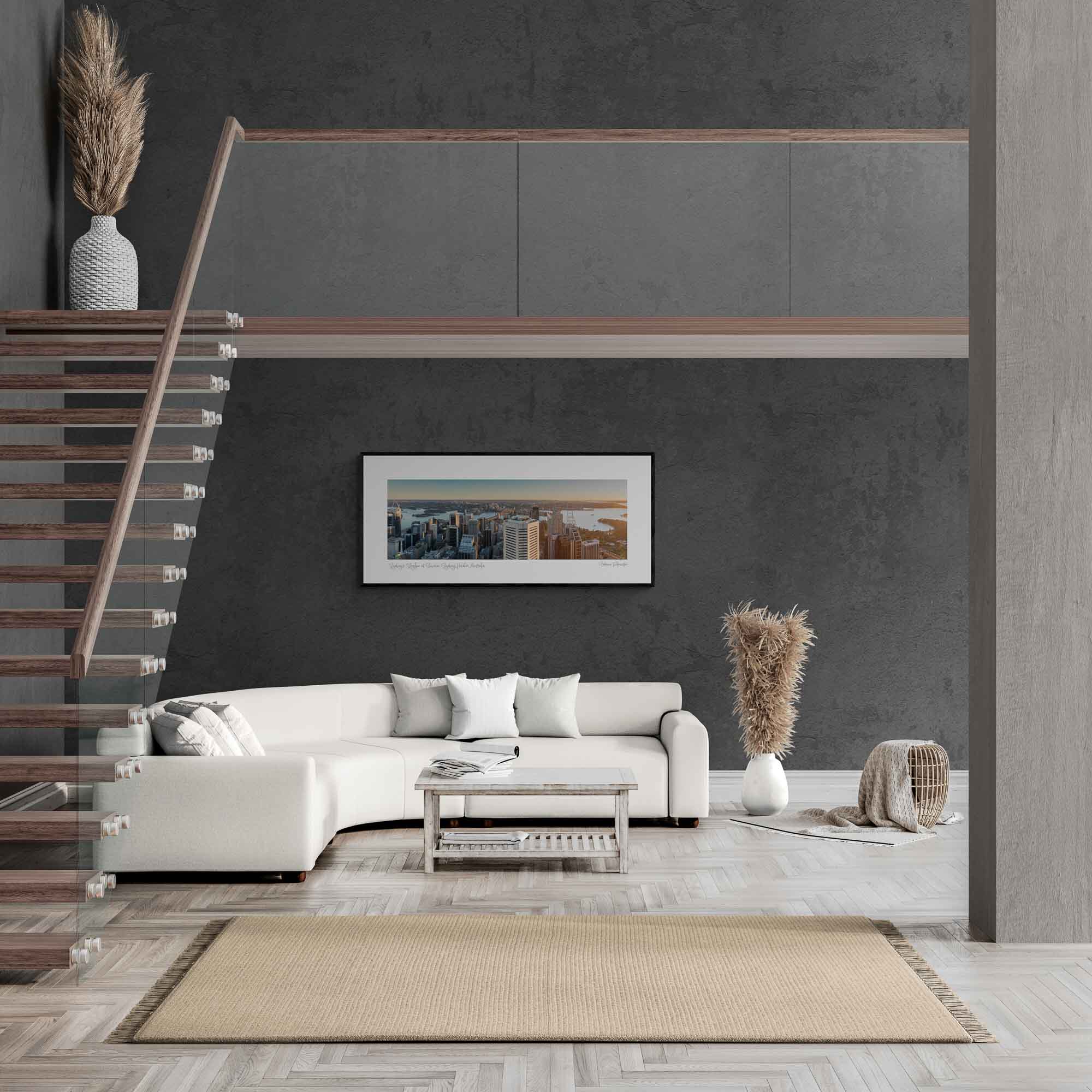 Panoramic view of Sydney Harbour at sunrise, with sunlight bathing the cityscape and water in golden hues.