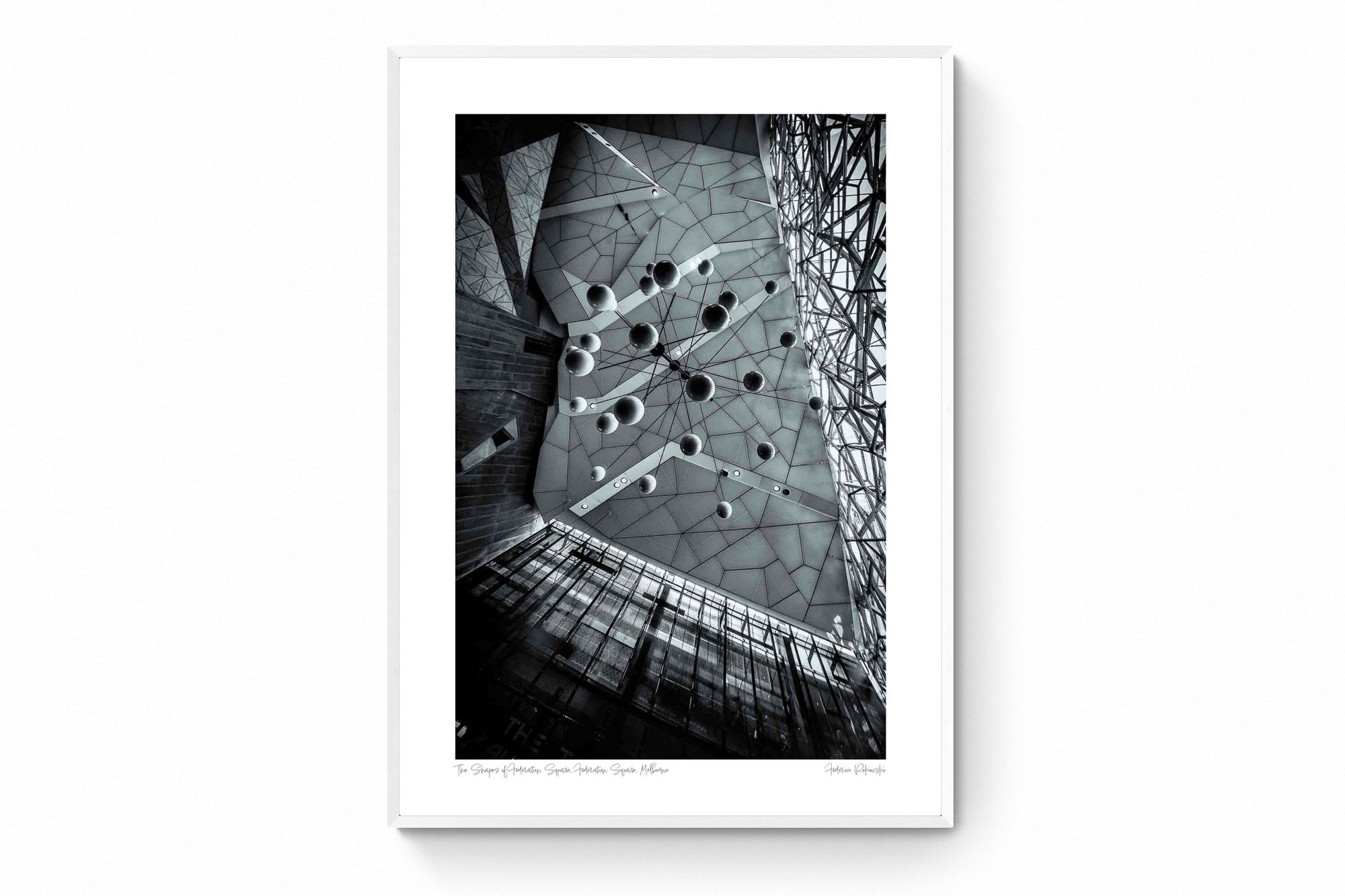 Black and white photo of the abstract geometric ceiling at Federation Square in Melbourne, with spherical elements hanging against the angular design.