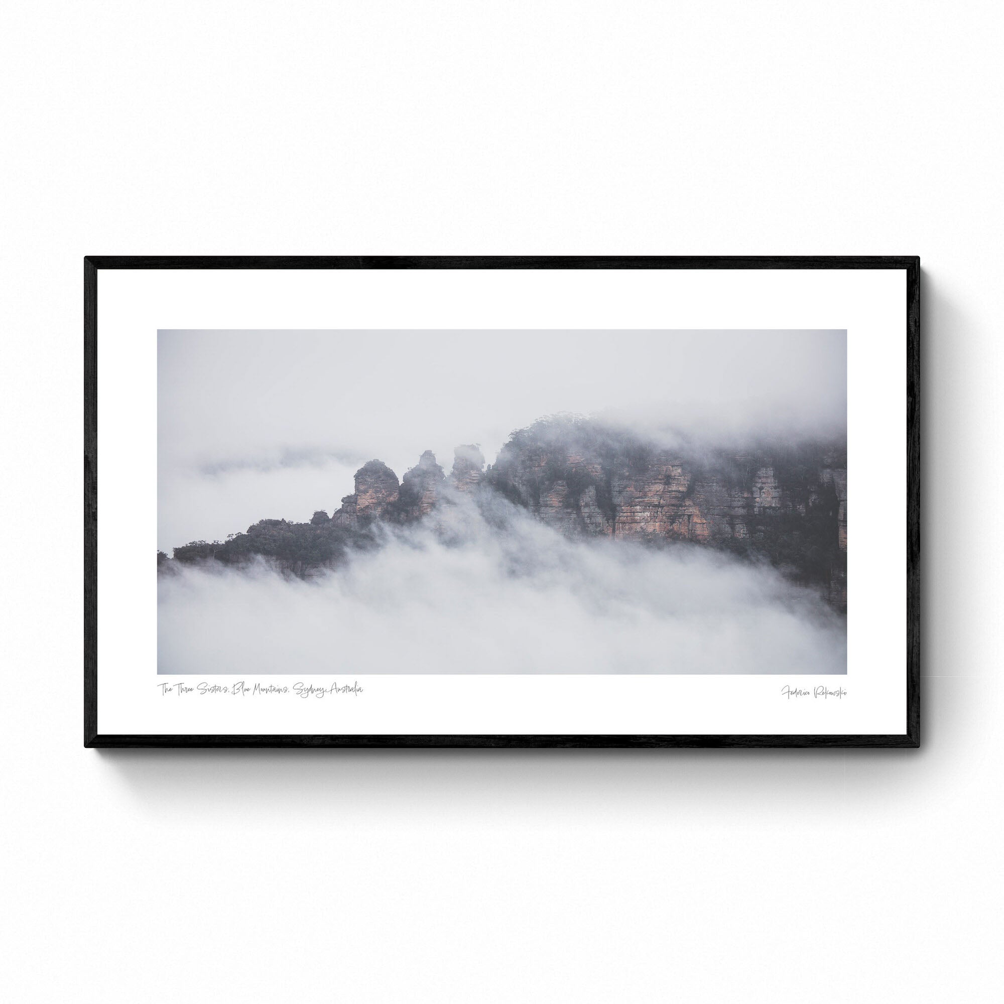 The Three Sisters rock formation in Sydney, Australia, is enshrouded in mist, as viewed from Sublime Point.