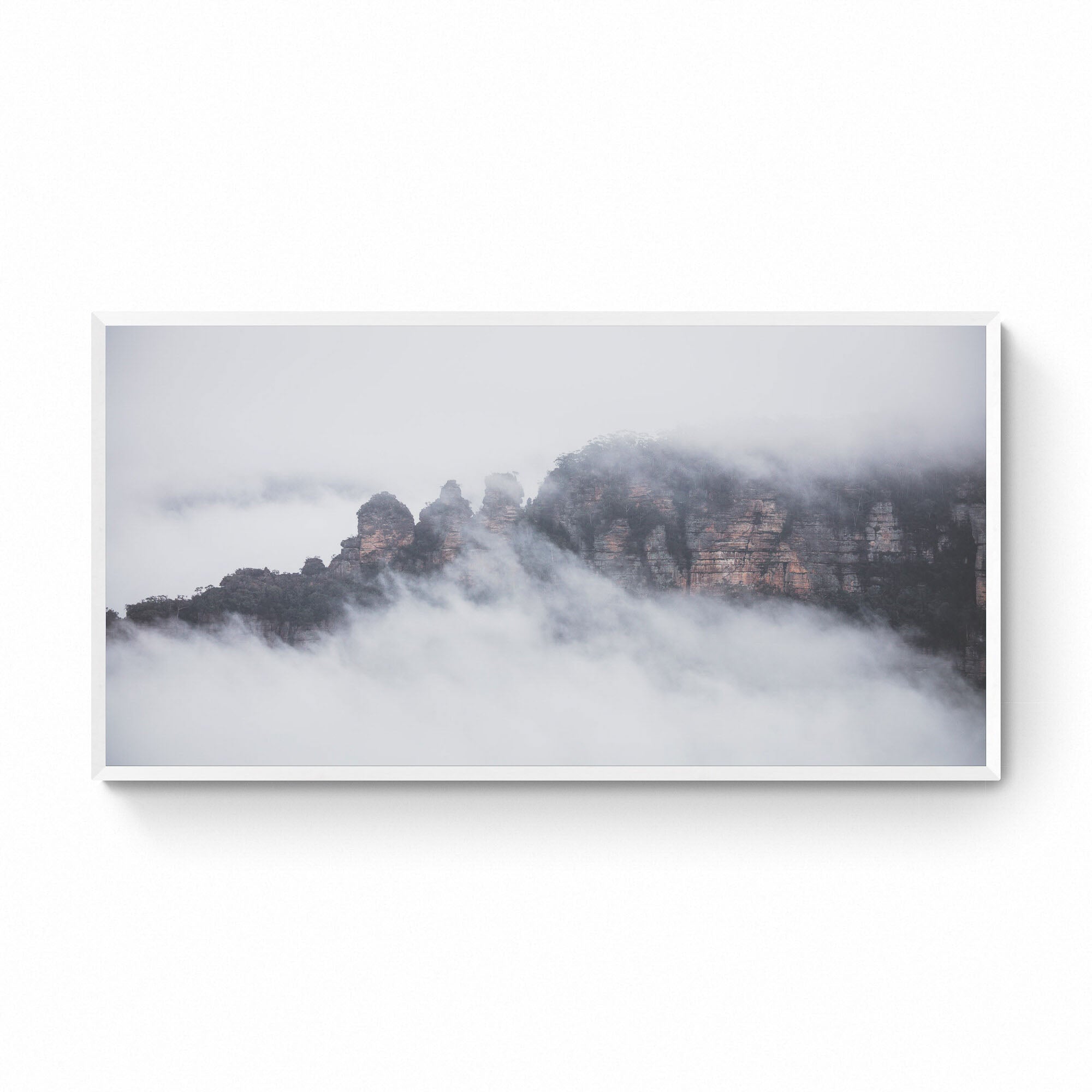 The Three Sisters rock formation in Sydney, Australia, is enshrouded in mist, as viewed from Sublime Point.