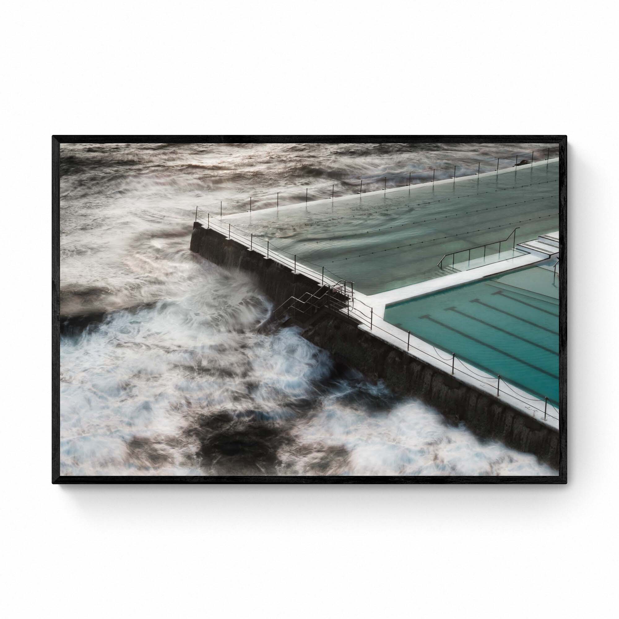 Long exposure of the Bondi Rock Pool in Sydney, with swirling ocean waves surrounding the calm waters of the pool.