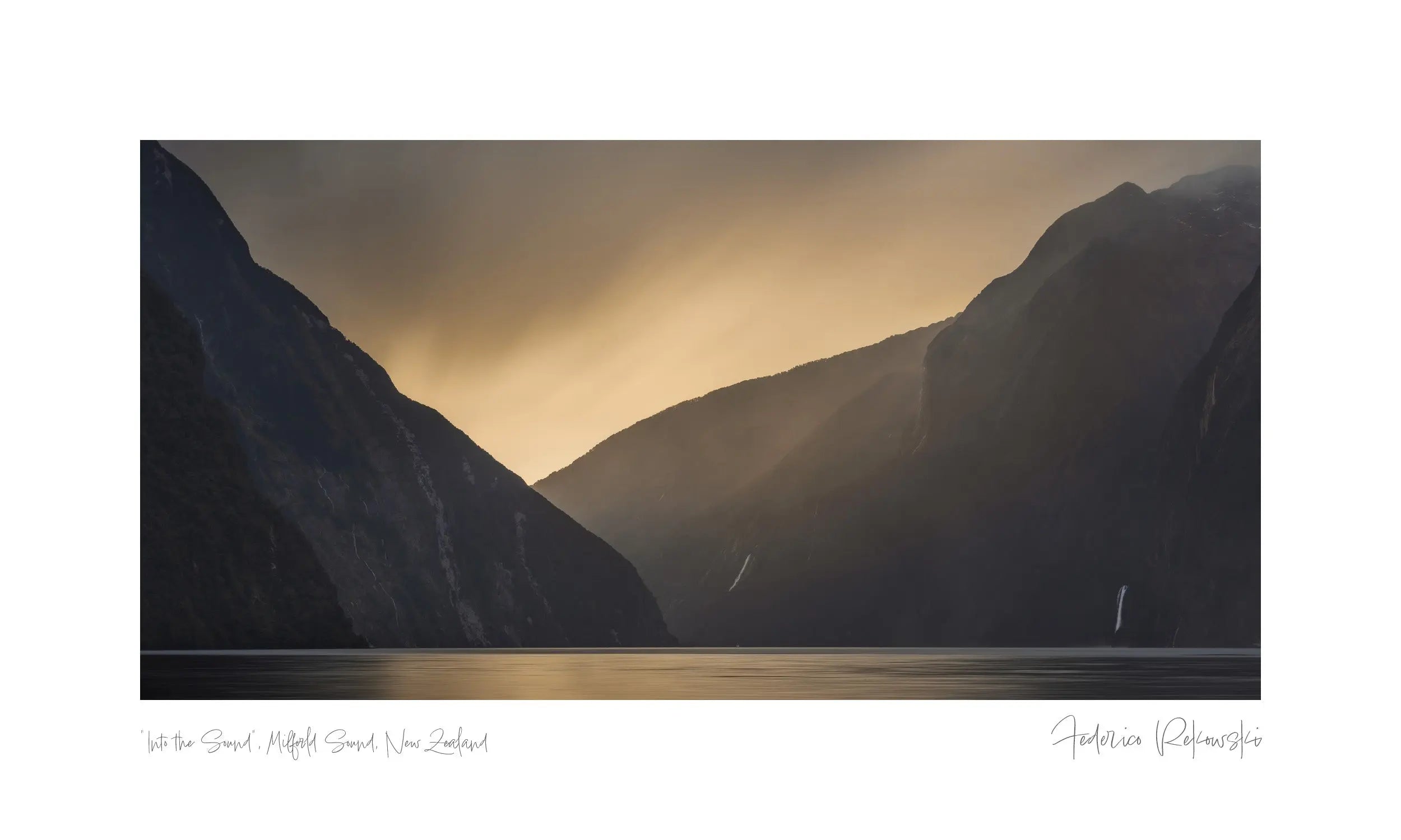 A sailboat sails on Milford Sound, New Zealand, with golden sunlight streaming through the mountainous valley.