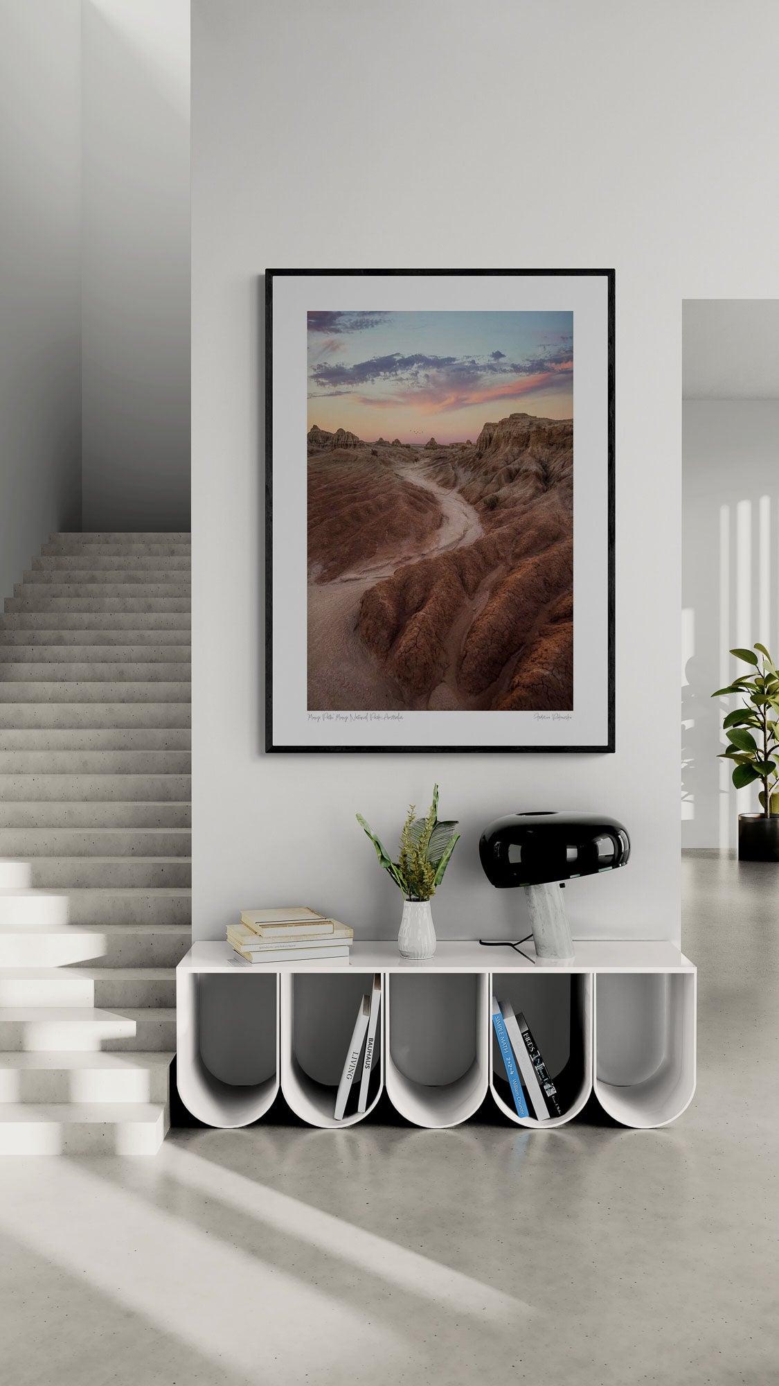 A dusty path through the eroded formations of Mungo National Park, under a sunset sky with streaks of pink and blue. Framed as wall art