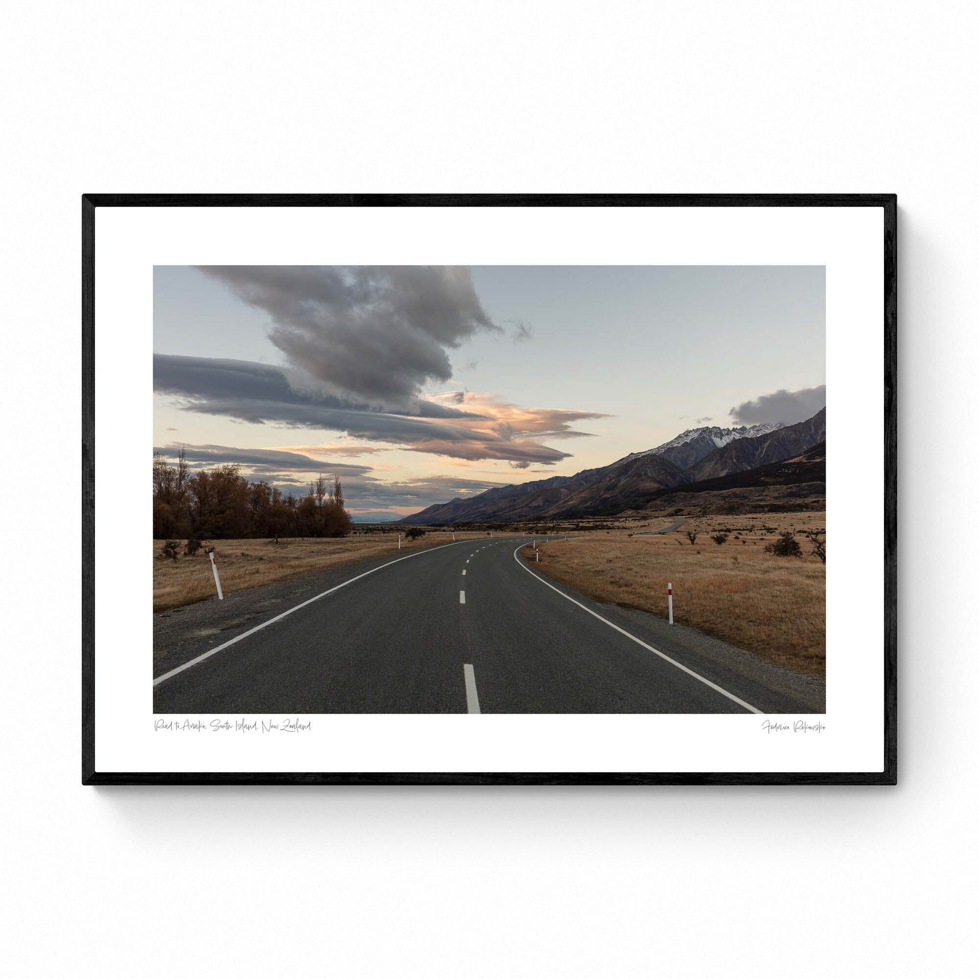 A serene landscape photograph of a road in New Zealand with Aoraki/Mt Cook in the background under a twilight sky with dynamic cloud formations.