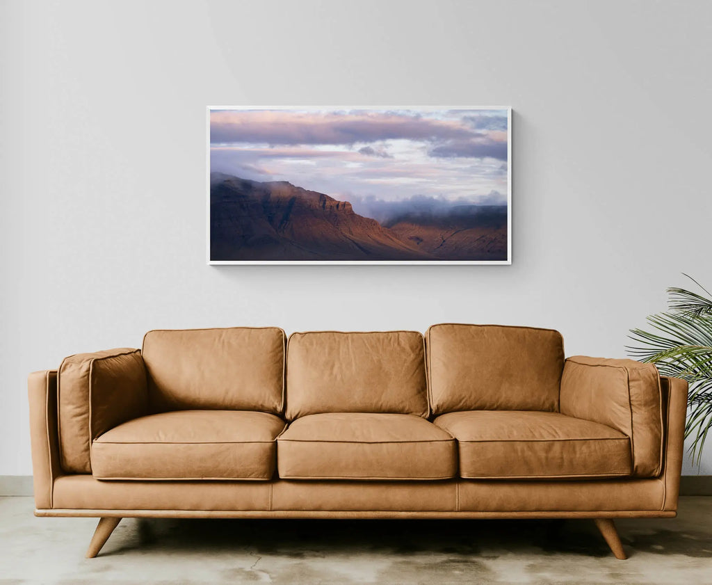 Late evening light bathes the Snæfellsnes Peninsula mountains in a warm glow with pink-tinged clouds above in Iceland.