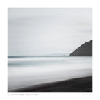 A minimalist long exposure photo of the calm sea meeting the dark sands of St. Clair's Beach in New Zealand, with a headland silhouette on the right.