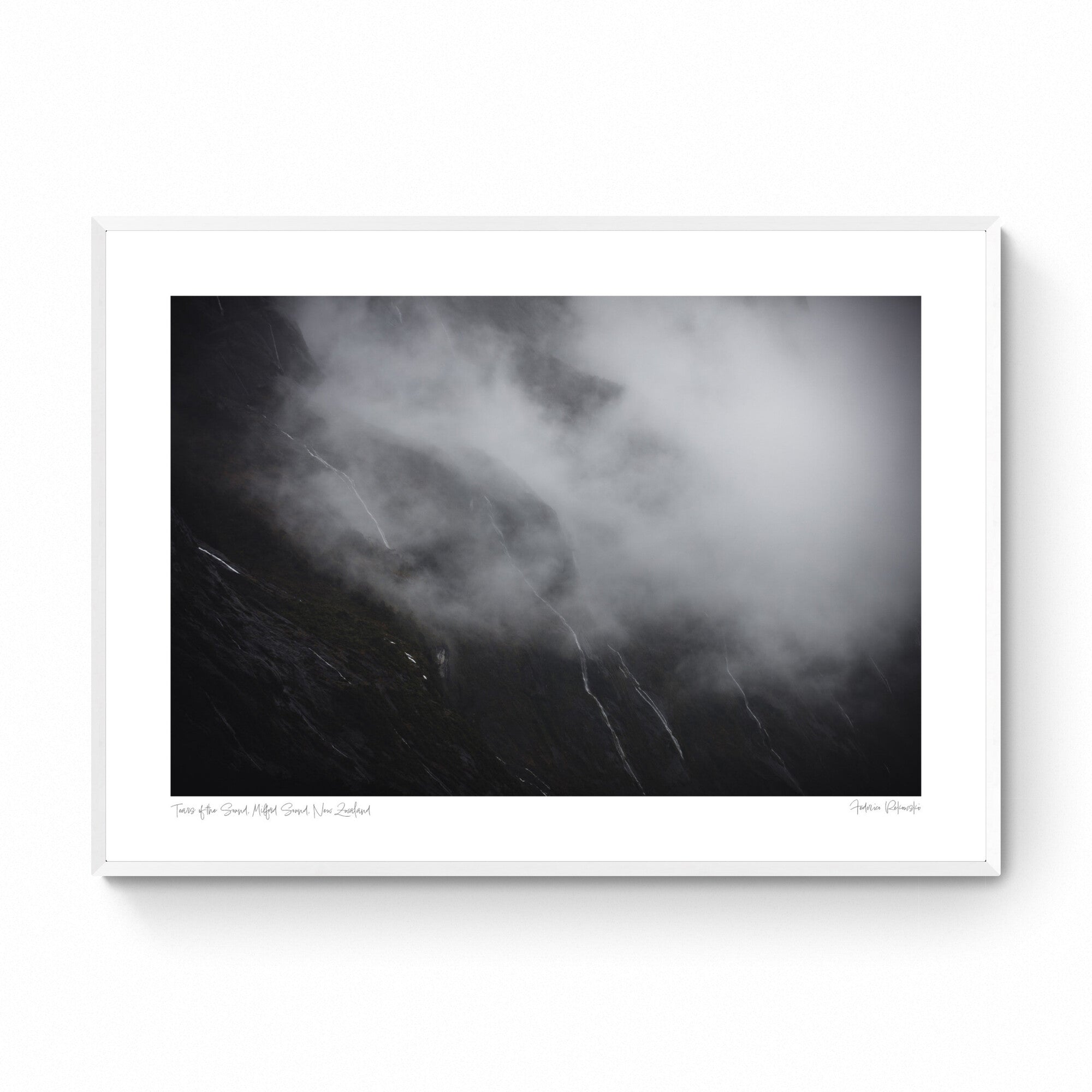 Photograph titled 'Tears of the Sound' showing misty waterfalls on the cliffs of Milford Sound, New Zealand, resembling tears against a somber backdrop.