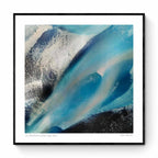 Overhead shot of contrasting blue glacial streams and ashy mountain terrain in an abstract Icelandic landscape.