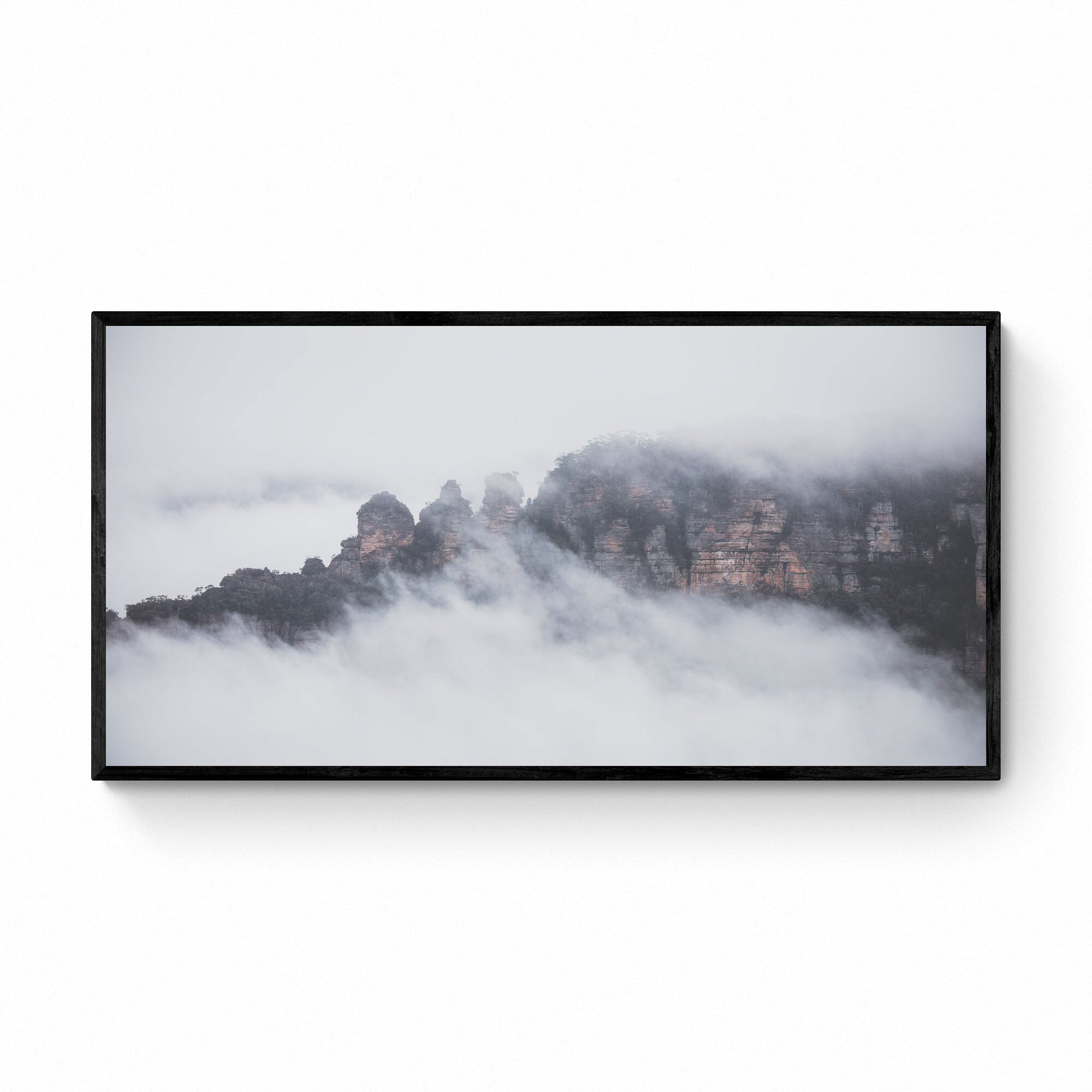 The Three Sisters rock formation in Sydney, Australia, is enshrouded in mist, as viewed from Sublime Point.