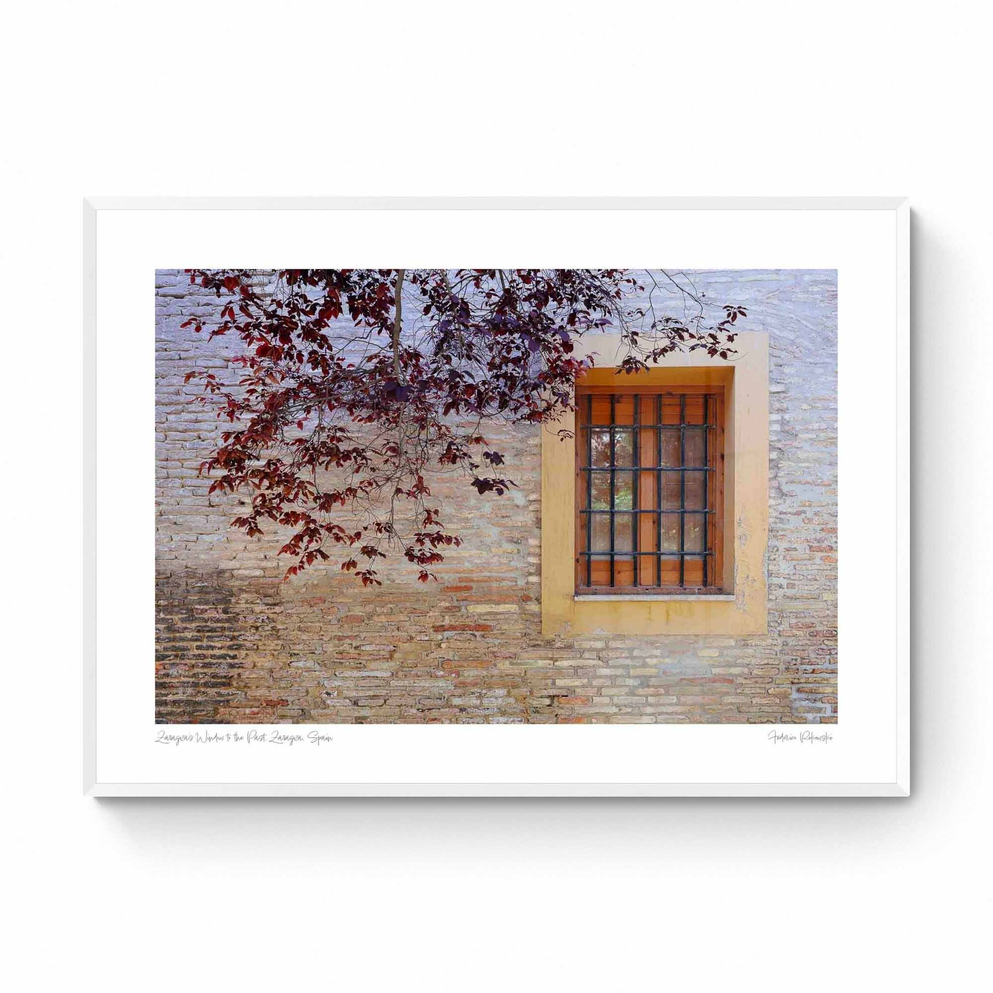 A rustic window with a yellow frame set in an old brick wall, adorned by autumn leaves, in Zaragoza, Spain.